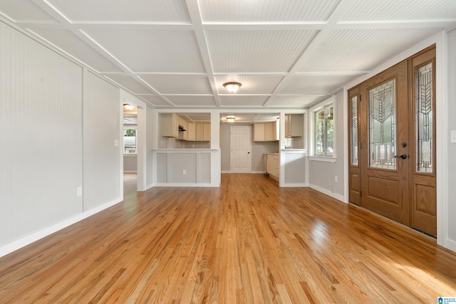 unfurnished living room with coffered ceiling and light hardwood / wood-style flooring