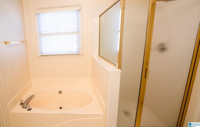 bathroom featuring separate shower and tub