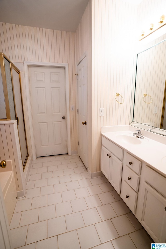 bathroom with tile patterned floors, vanity, and a shower with shower door