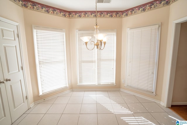 unfurnished dining area featuring light tile patterned floors and an inviting chandelier