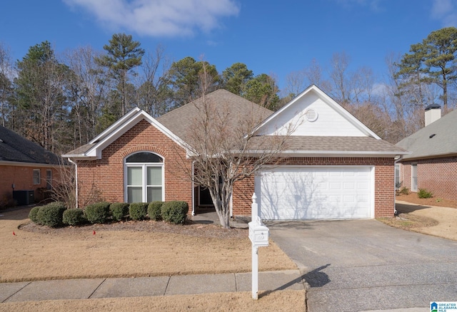 view of front of home with a garage and central AC unit