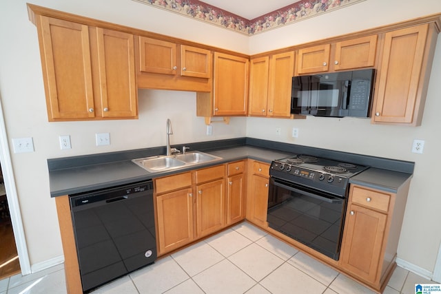 kitchen featuring sink, light tile patterned flooring, and black appliances