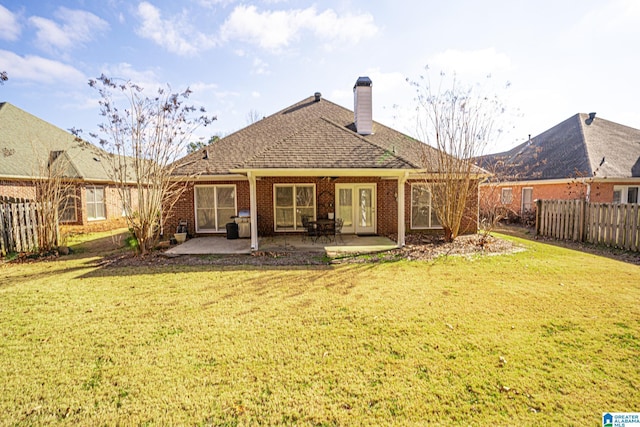 rear view of house featuring a yard and a patio area