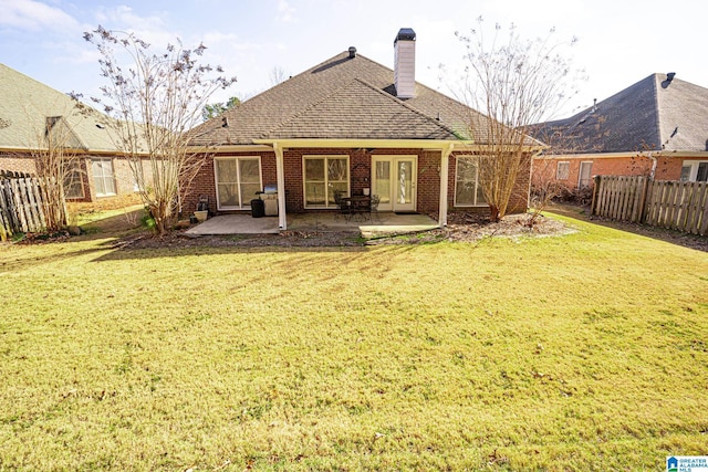 back of house featuring a patio area and a yard