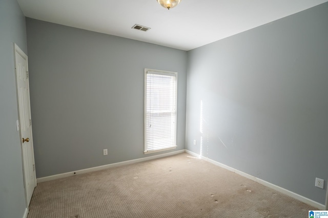 unfurnished room featuring light colored carpet