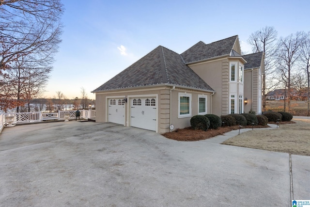 property exterior at dusk featuring a garage