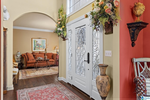 entryway with ornamental molding and dark wood-type flooring