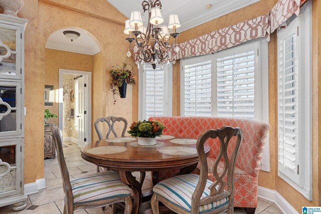 dining area with ornamental molding and a notable chandelier