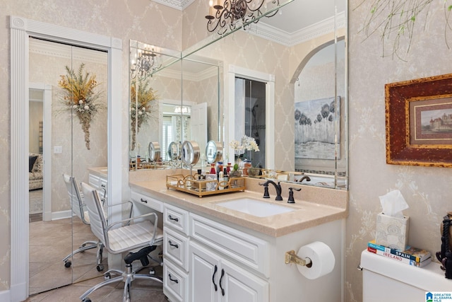 bathroom with tile patterned floors, crown molding, vanity, and toilet