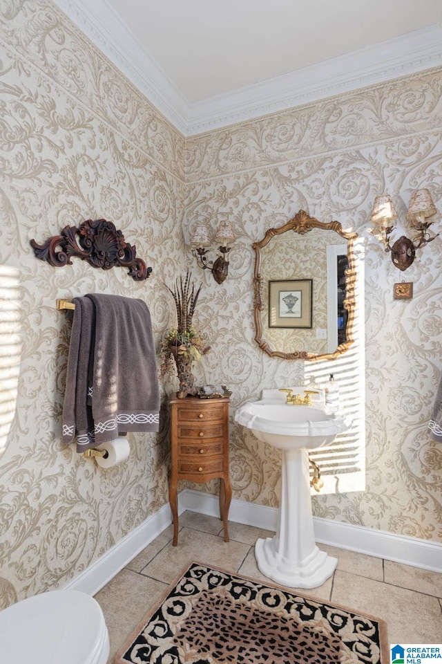 bathroom with toilet, tile patterned flooring, and ornamental molding