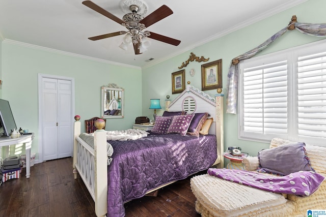 bedroom with a closet, dark wood-type flooring, ceiling fan, and crown molding