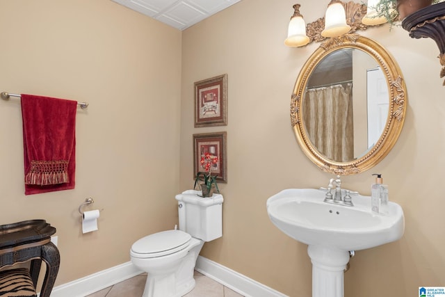 bathroom with toilet and tile patterned floors