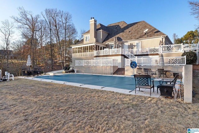 view of pool featuring a sunroom and a patio