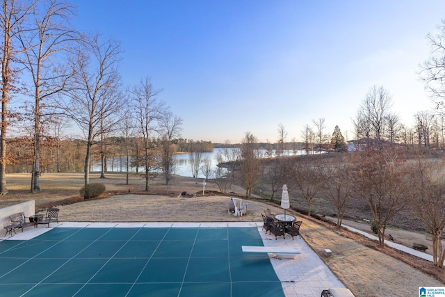 view of pool featuring a water view