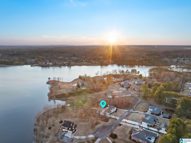 aerial view at dusk with a water view