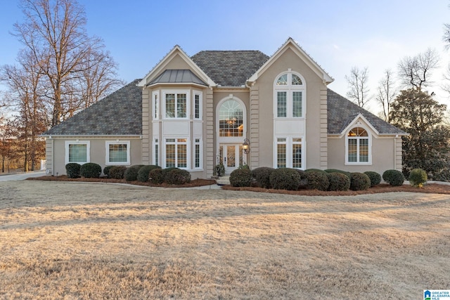 view of front property featuring french doors and a front yard