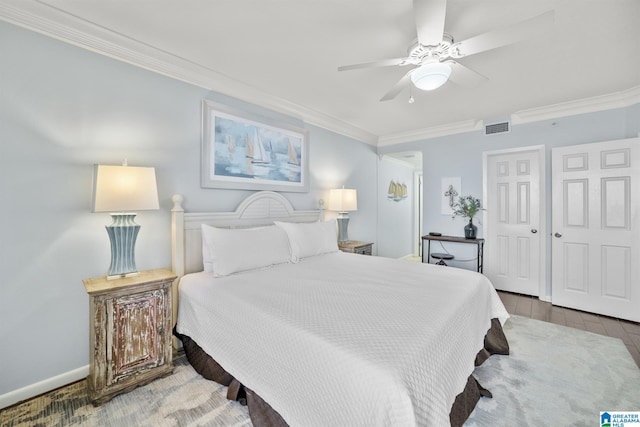 bedroom featuring ceiling fan, a closet, crown molding, and dark wood-type flooring