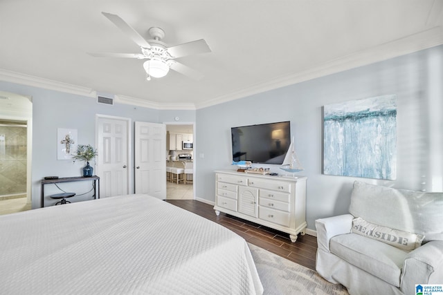 bedroom featuring ceiling fan, crown molding, and ensuite bath