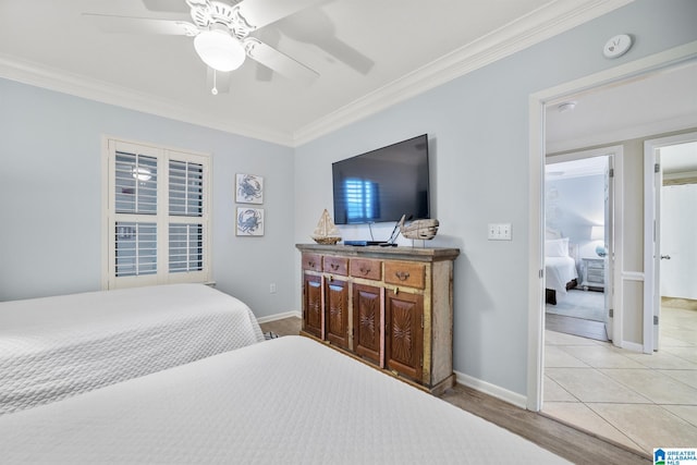 tiled bedroom with ceiling fan and crown molding