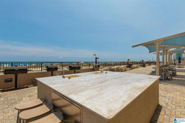 view of patio / terrace featuring a water view and grilling area