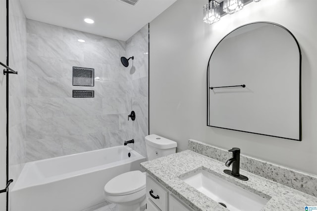 full bathroom featuring vanity, tiled shower / bath combo, and toilet