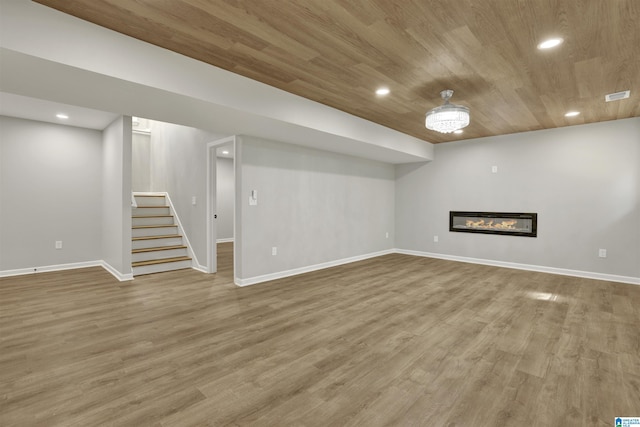 basement featuring hardwood / wood-style floors and wooden ceiling