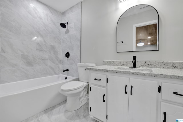 full bathroom featuring vanity, tiled shower / bath combo, and toilet