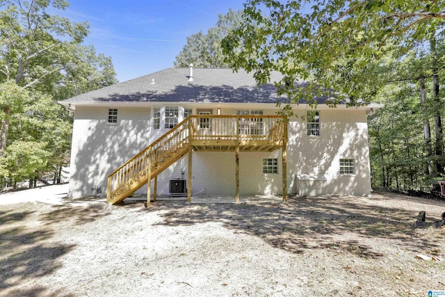 rear view of house featuring cooling unit and a deck