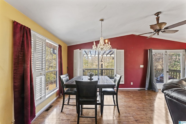 dining area with vaulted ceiling, french doors, hardwood / wood-style floors, ceiling fan with notable chandelier, and ornamental molding