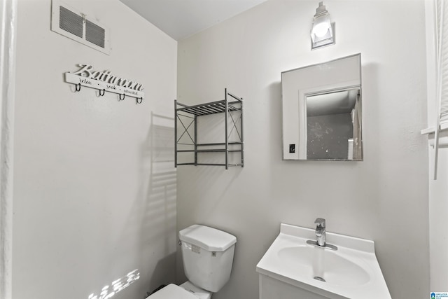 bathroom featuring toilet and vanity