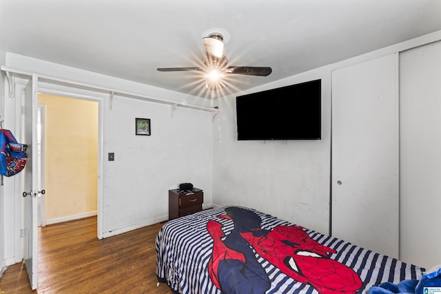 bedroom with ceiling fan and dark hardwood / wood-style flooring