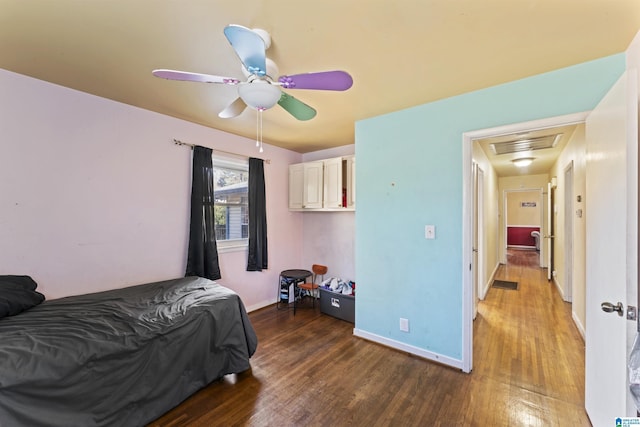 bedroom with ceiling fan and dark wood-type flooring