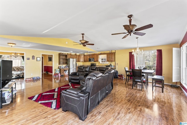 living room featuring ceiling fan with notable chandelier, light hardwood / wood-style flooring, and lofted ceiling