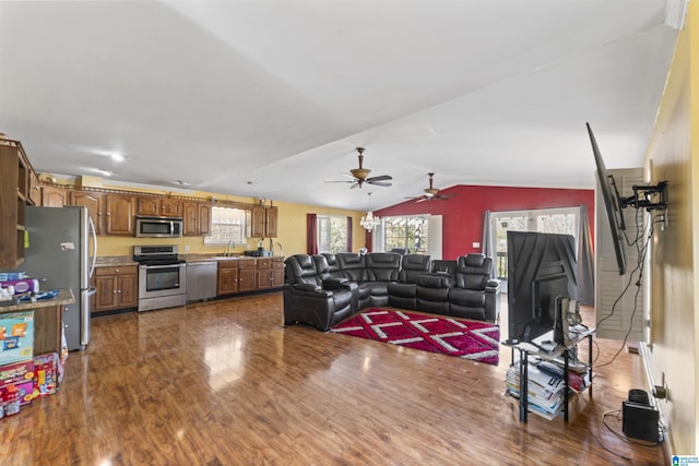 living room with sink, dark wood-type flooring, and lofted ceiling