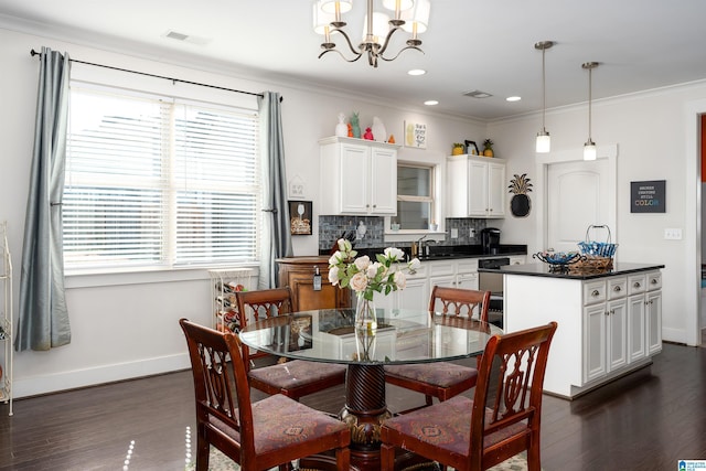 dining room with crown molding, dark wood-type flooring, and a wealth of natural light