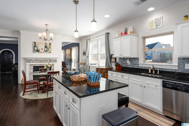 kitchen featuring white cabinets, sink, dishwasher, and a center island