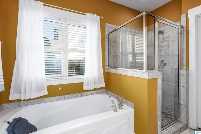 bathroom featuring shower with separate bathtub