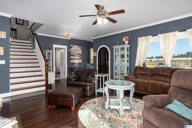 living room featuring dark hardwood / wood-style flooring, ornamental molding, and ceiling fan