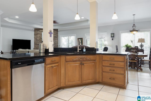 kitchen with stainless steel dishwasher, a raised ceiling, crown molding, and hanging light fixtures