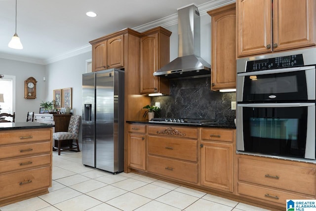 kitchen featuring appliances with stainless steel finishes, dark stone counters, ornamental molding, decorative backsplash, and wall chimney exhaust hood