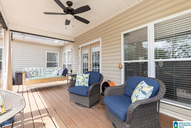 wooden deck with ceiling fan and an outdoor living space