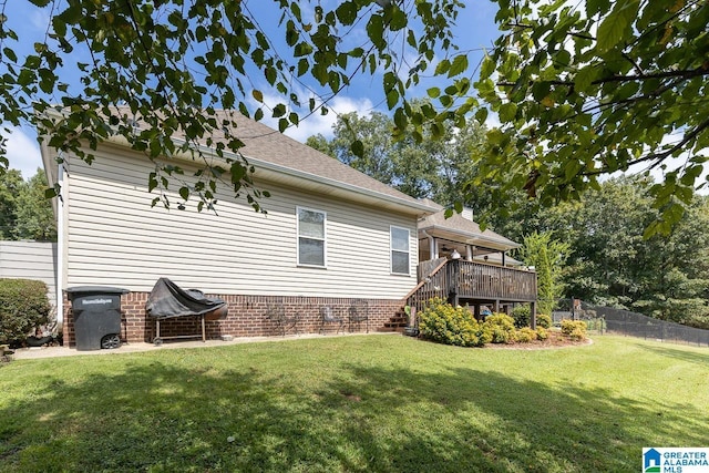 view of property exterior featuring a yard and a wooden deck