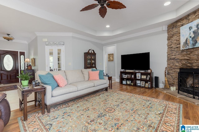 living room featuring french doors, ceiling fan, crown molding, and wood-type flooring