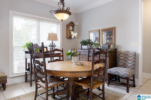 dining area with a wealth of natural light, ornamental molding, and light tile patterned flooring