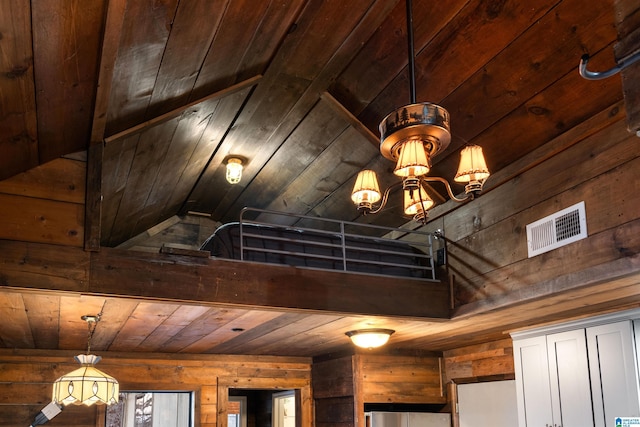 room details featuring a notable chandelier, wood ceiling, and wood walls