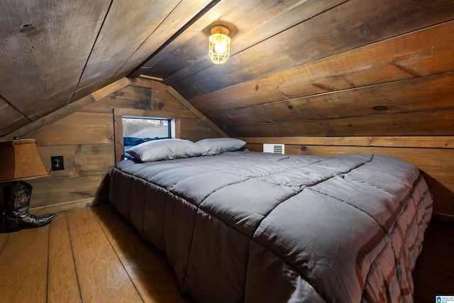 bedroom featuring wooden walls, wooden ceiling, vaulted ceiling, and hardwood / wood-style flooring