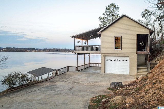 view of property exterior featuring a garage and a water view