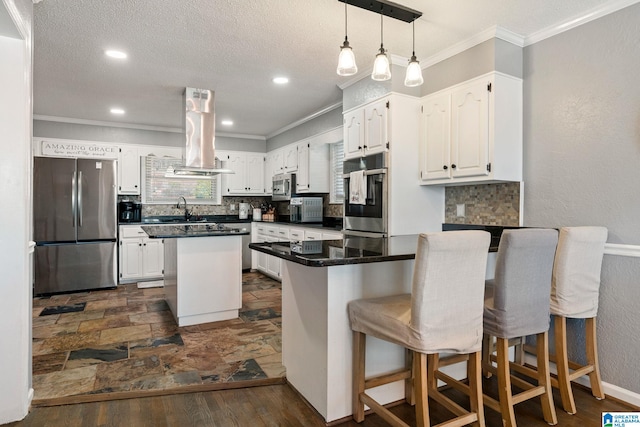 kitchen with stainless steel appliances, a center island, island range hood, and white cabinets