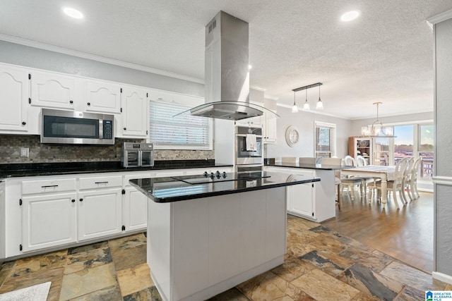 kitchen featuring white cabinetry, a kitchen island, stainless steel appliances, and island exhaust hood