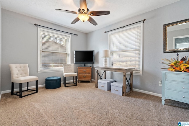 living area featuring light carpet, a textured ceiling, and ceiling fan